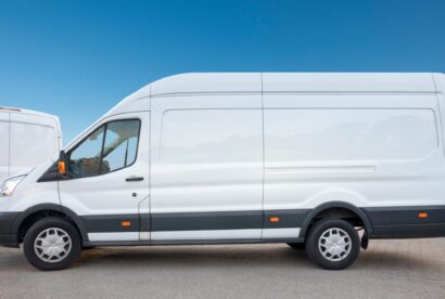 White van parked, showcasing Shahs logistics courier insurance and tracking.