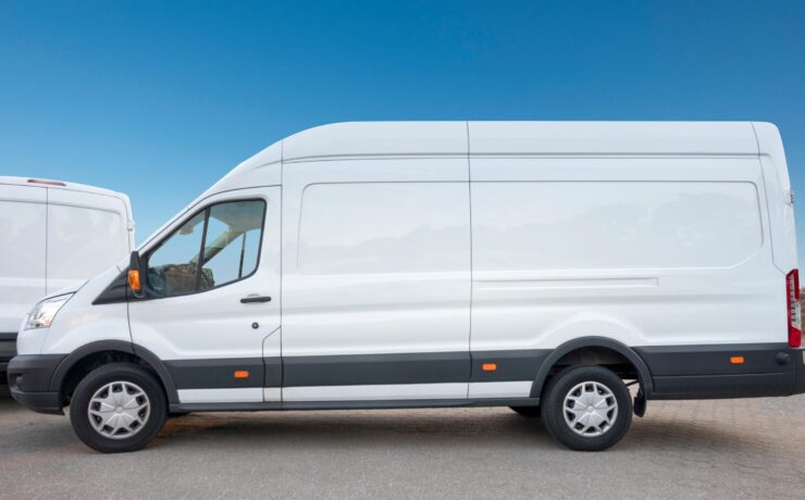White van parked, showcasing Shahs logistics courier insurance and tracking.