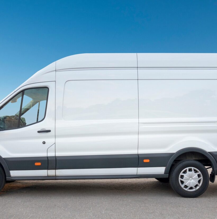 White van parked, showcasing Shahs logistics courier insurance and tracking.